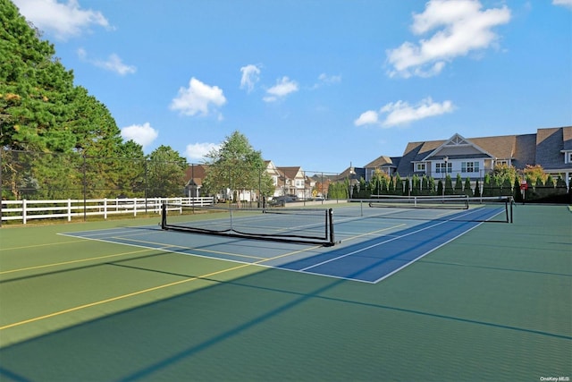 view of tennis court featuring basketball hoop