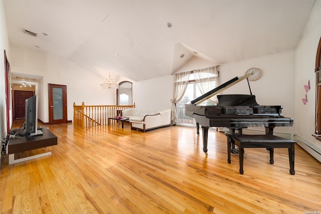 misc room with a chandelier, lofted ceiling, and light hardwood / wood-style flooring