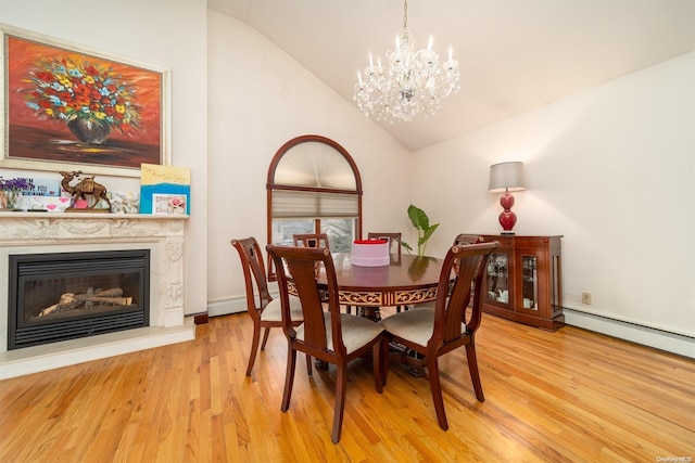 dining area with a baseboard radiator, light hardwood / wood-style floors, lofted ceiling, and a notable chandelier