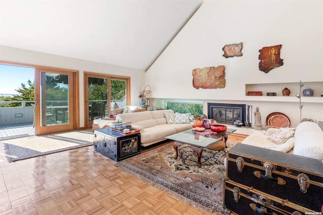 living room featuring high vaulted ceiling and light parquet floors