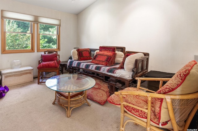 carpeted living room featuring vaulted ceiling