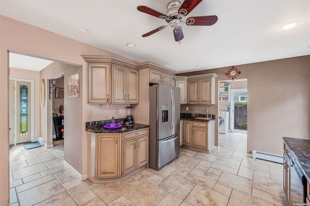 kitchen with stainless steel fridge, light brown cabinetry, ceiling fan, a baseboard heating unit, and washer / clothes dryer