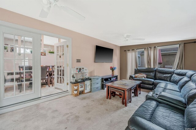 carpeted living room with ceiling fan