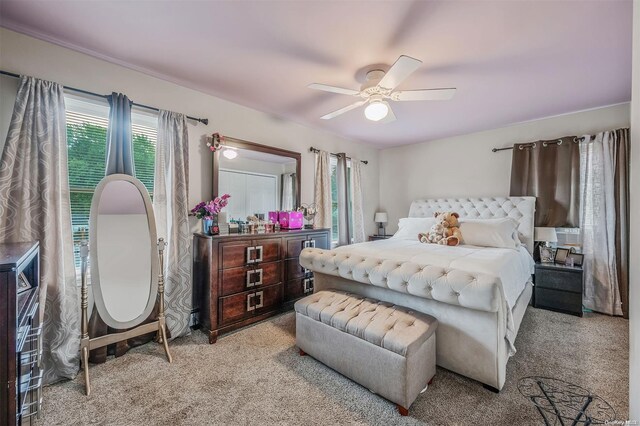 carpeted bedroom featuring ceiling fan