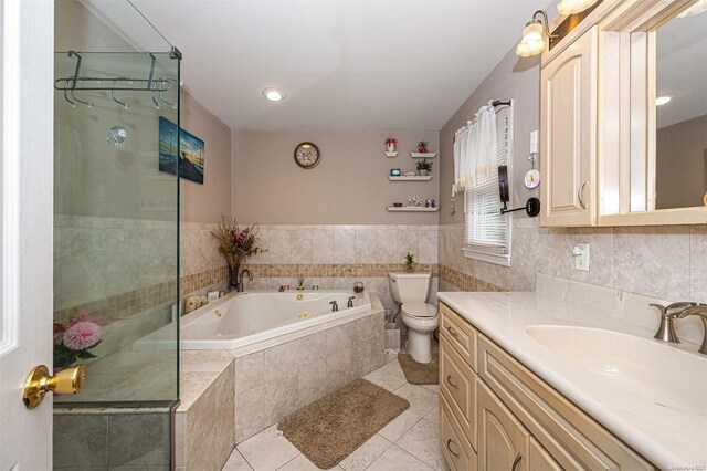 full bathroom featuring tile patterned floors, vanity, separate shower and tub, and toilet