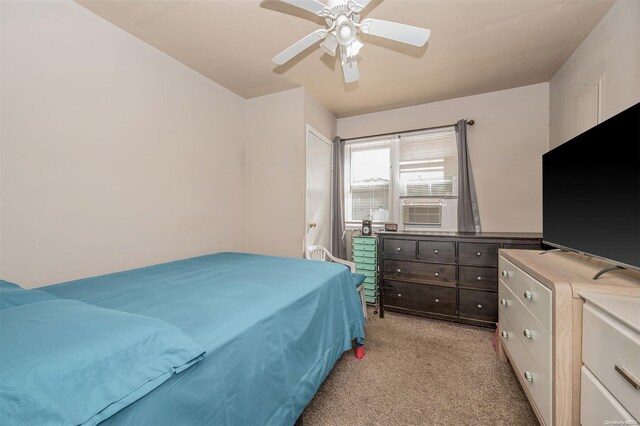 bedroom with light carpet, ceiling fan, and cooling unit