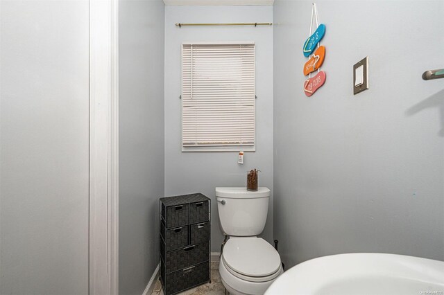 bathroom with tile patterned flooring and toilet