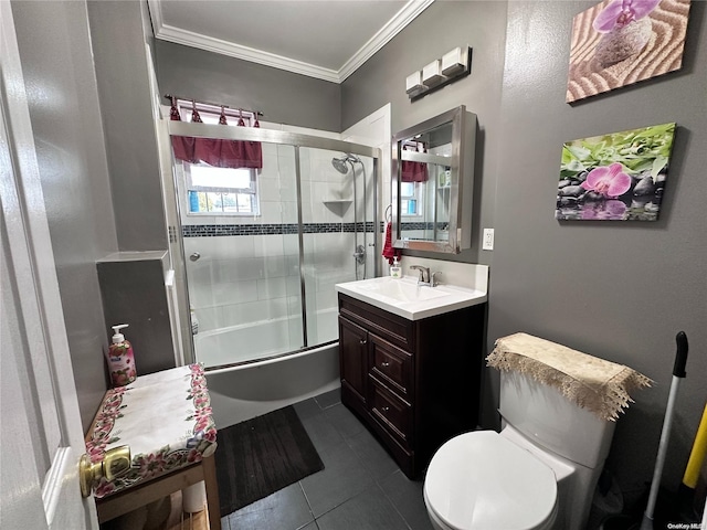 full bathroom with bath / shower combo with glass door, vanity, crown molding, tile patterned flooring, and toilet