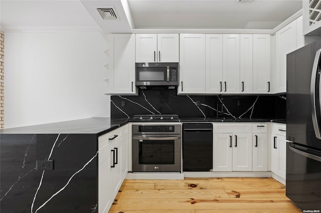583 Putnam Ave Unit 4, Brooklyn, NY 11221 - kitchen featuring stainless steel microwave, wall oven, freestanding refrigerator, tasteful backsplash, and ornamental molding