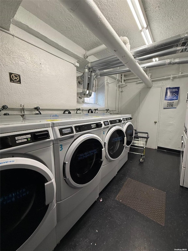 clothes washing area featuring a textured ceiling and separate washer and dryer