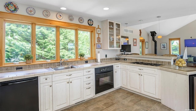 kitchen featuring pendant lighting, black appliances, white cabinets, vaulted ceiling, and kitchen peninsula