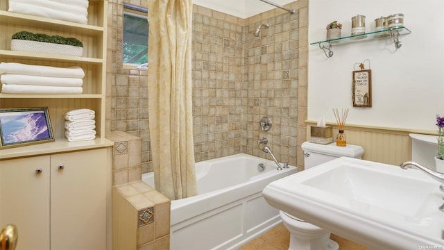 full bathroom featuring shower / tub combo with curtain, tile patterned floors, toilet, and sink