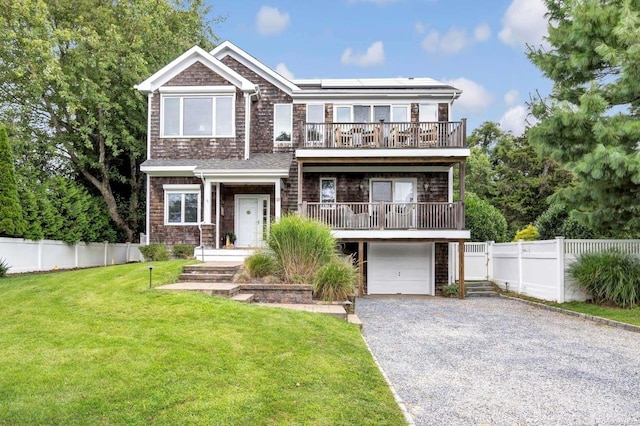 25 Oceanview Dr, Southampton, NY 11968 - shingle-style home with driveway, solar panels, a balcony, a front lawn, and an attached garage