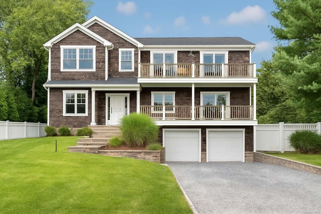25 Oceanview Dr, Southampton, NY 11968 - view of front facade featuring a garage, aphalt driveway, fence, a balcony, and a front yard