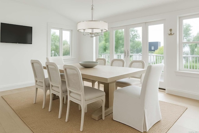 25 Oceanview Dr, Southampton, NY 11968 - dining area with baseboards, lofted ceiling, and a notable chandelier