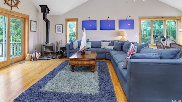 25 Oceanview Dr, Southampton, NY 11968 - living room featuring wood finished floors, a wood stove, lofted ceiling, and visible vents