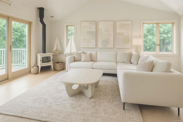 25 Oceanview Dr, Southampton, NY 11968 - living room featuring wood finished floors, a wood stove, and lofted ceiling