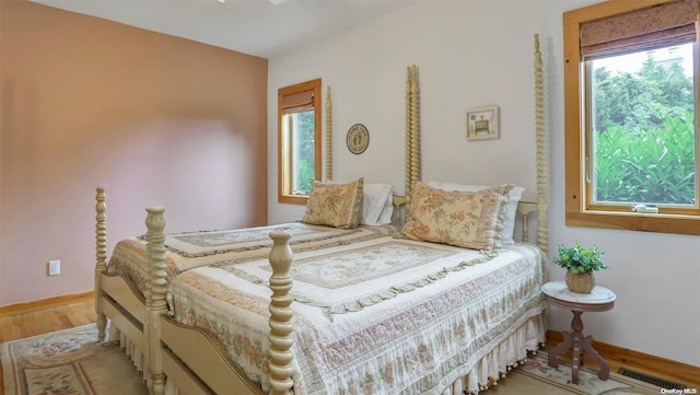 25 Oceanview Dr, Southampton, NY 11968 - bedroom with visible vents, baseboards, wood finished floors, and multiple windows