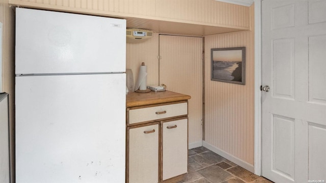 25 Oceanview Dr, Southampton, NY 11968 - kitchen with baseboards, freestanding refrigerator, stone finish floor, and light countertops
