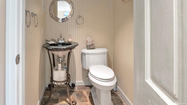 25 Oceanview Dr, Southampton, NY 11968 - bathroom featuring a sink, baseboards, toilet, and stone finish flooring