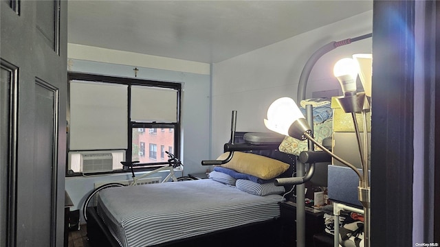 bedroom featuring hardwood / wood-style floors and cooling unit