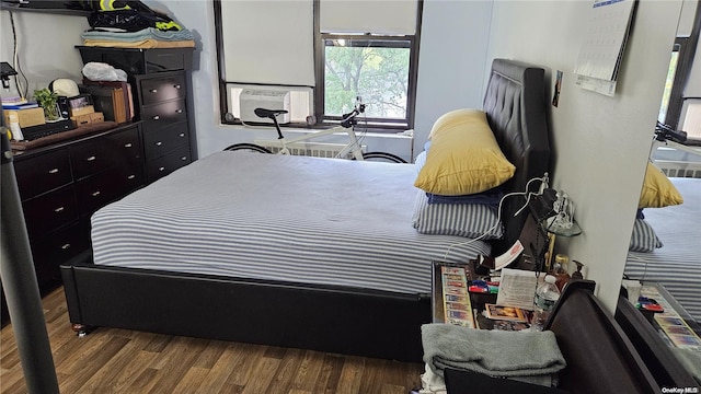 bedroom with hardwood / wood-style flooring and cooling unit