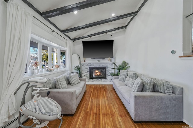 living room featuring vaulted ceiling with beams, a fireplace, and hardwood / wood-style flooring