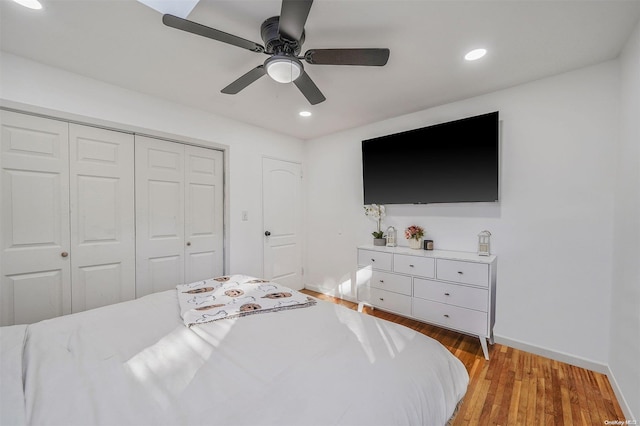 bedroom with a closet, ceiling fan, and light hardwood / wood-style flooring