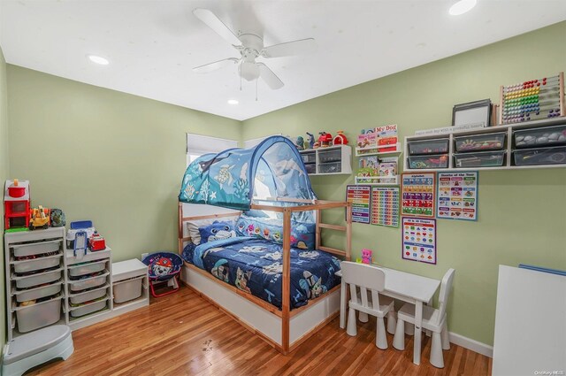 bedroom with ceiling fan and hardwood / wood-style flooring