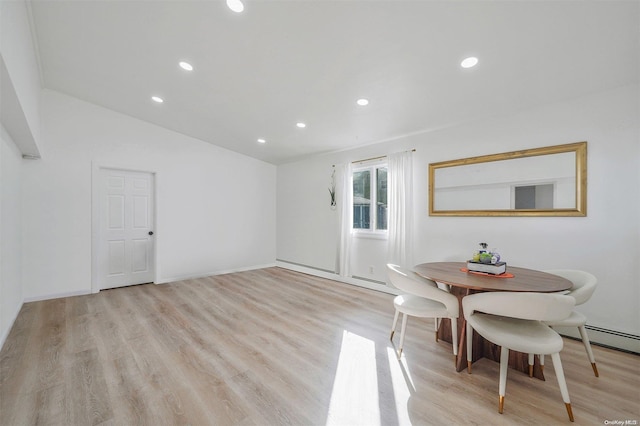 dining space featuring light hardwood / wood-style floors and lofted ceiling