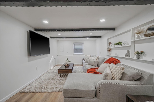 living room with beam ceiling and light hardwood / wood-style floors