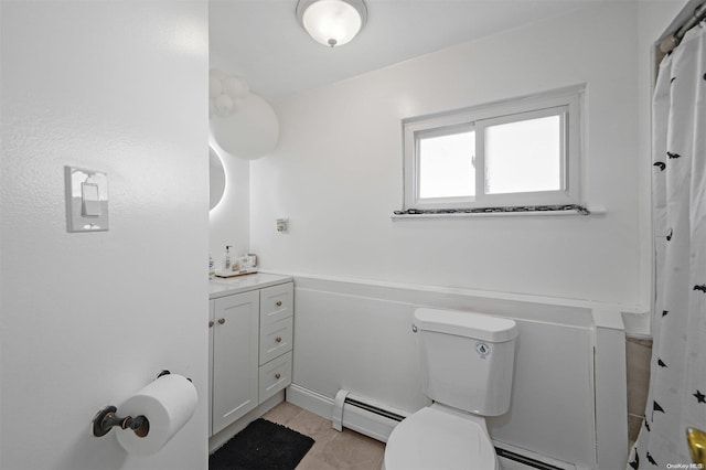 bathroom with tile patterned floors, vanity, toilet, and baseboard heating