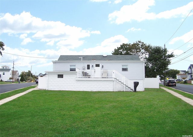 back of property featuring a yard