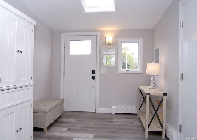 entrance foyer with light hardwood / wood-style floors and a baseboard radiator