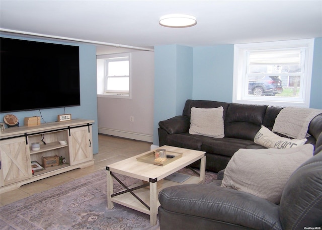 living room with light tile patterned flooring and a baseboard heating unit