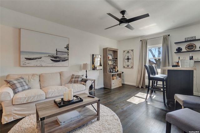 living room with ceiling fan and dark hardwood / wood-style flooring