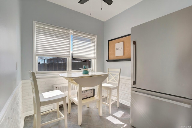 dining space featuring tile patterned floors and ceiling fan