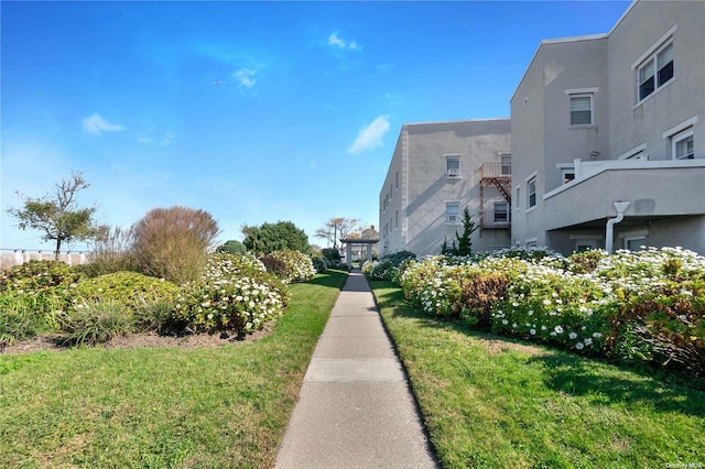 view of property's community with a lawn