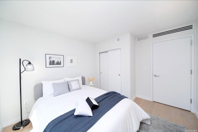 136-80 41st Ave Unit 4A, Flushing, NY 11355 - bedroom with light wood-style flooring, a closet, and baseboards