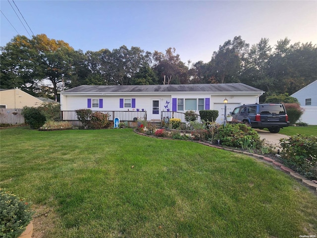 view of front facade featuring a front lawn and a garage