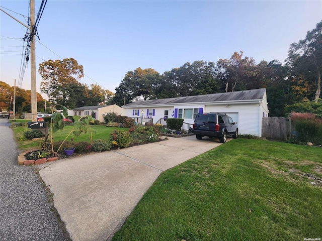 view of front facade with a front yard and a garage