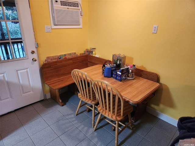 tiled dining area featuring a wall mounted AC