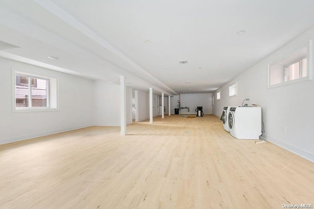 basement featuring separate washer and dryer and light hardwood / wood-style floors