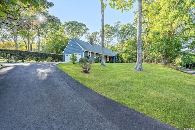 view of front of property with a garage and a front lawn