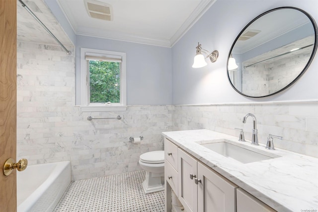 bathroom with tile patterned floors, ornamental molding, vanity, tile walls, and toilet