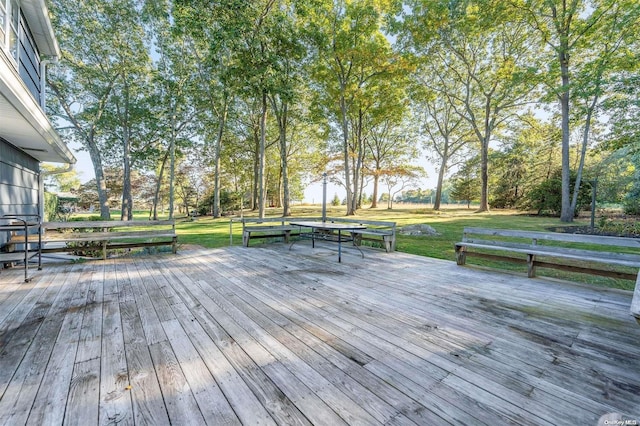 wooden deck featuring a lawn