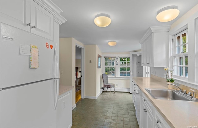 kitchen featuring white cabinets, white appliances, and sink