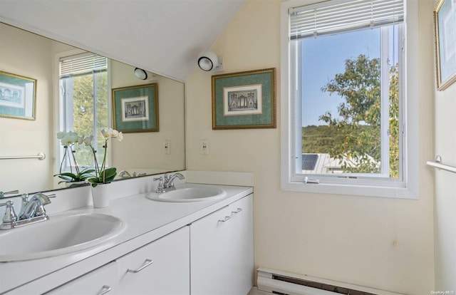 bathroom with vanity, lofted ceiling, baseboard heating, and a healthy amount of sunlight