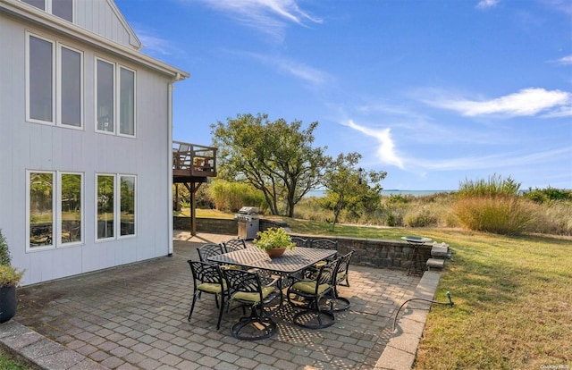 view of patio with a wooden deck and grilling area