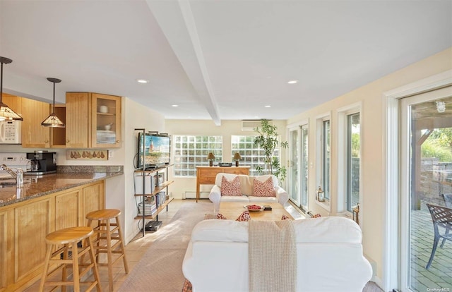 living room featuring beam ceiling, a baseboard radiator, and sink